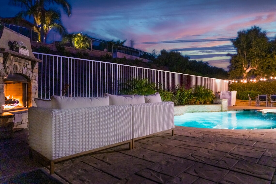 luxury pool patio evening fireplace